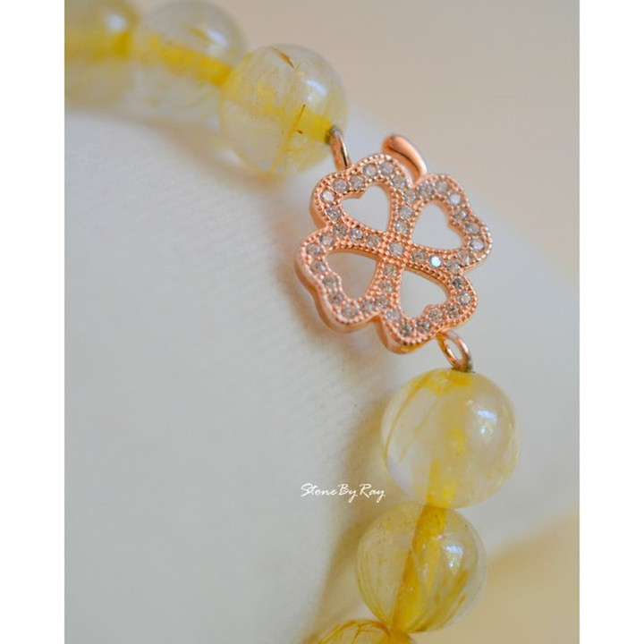 Pulsera de seda dorada con dije de trébol de cuatro hojas